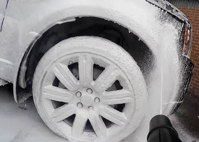 Snow foaming a car